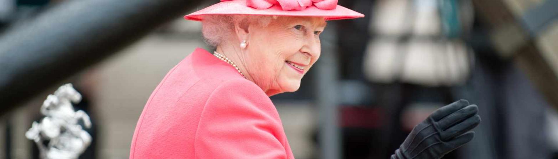 Photo of Queen Elizabeth II wearing a pink hat and coat