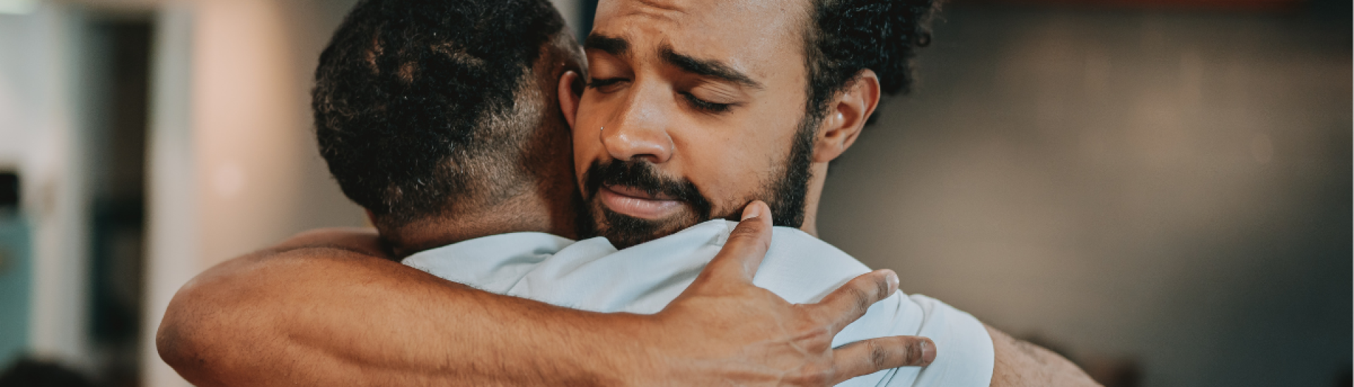 Two men hugging