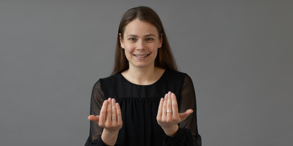 Female british sign language interpreter signing welcome