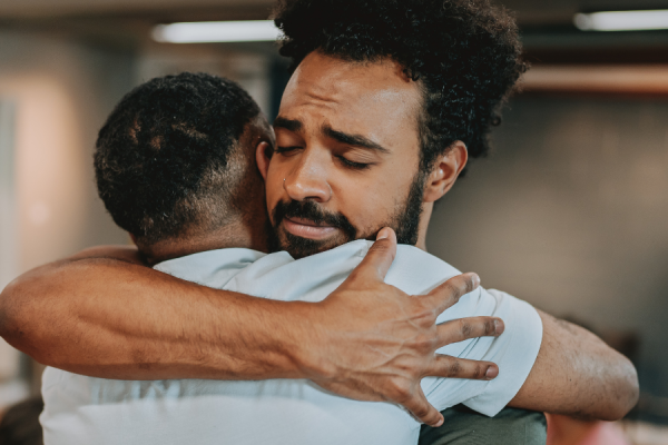 Two men hugging